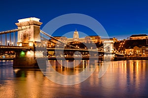 Chain Bridge, Royal Palace and Danube river in Budapest at night.