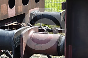 Chain coupler connecting freight wagons, large wagon buffers visible.. photo