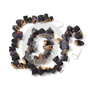 Chain of dried Turkish eggplants on white background close up