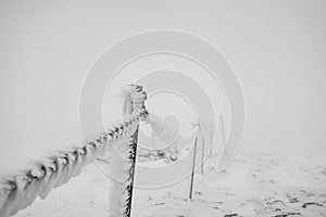 Chain fencing covered with ice and snow