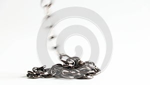 The chain goes down and lies in a pile