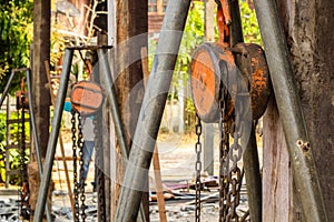 Chain hoist with a large wooden pole.