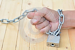 Chain and key lock the hand of person, Metal chain, locked padlock and keyhole