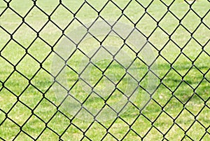 Chain link fence against grass