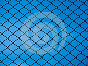 Chain link fence on blue background