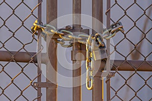 Chain link fence closed with padlock and chain
