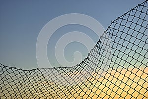 Chain link fence on evening sky