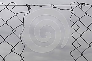 Chain link fence with hole damage wire background
