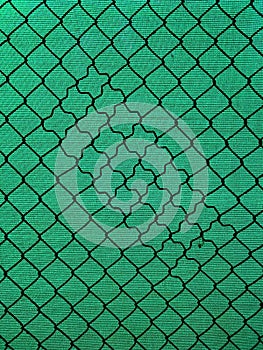 Chain-link fencing with the diamond pattern and green fiber screening