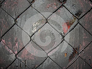 Chain link mesh on a gray painted background - vandal-proof protection of municipal and departmental property. no graffiti