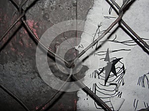 Chain link mesh on a gray painted background - vandal-proof protection of municipal and departmental property. no graffiti