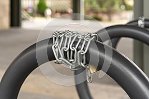 Chain lock for bike safety in the bike parking with gray iron rings