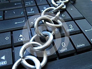 Chain and lock on laptop keyboard. Computer ban, internet ban. Addiction. Anti virus