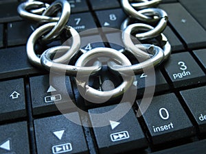 Chain and lock on laptop keyboard. Computer ban, internet ban. Addiction. Anti virus