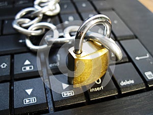 Chain and lock on laptop keyboard. Computer ban, internet ban. Addiction. Anti virus