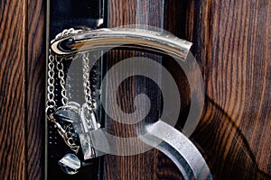 Chain and lock on a wooden door