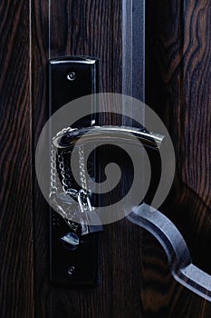 Chain and lock on a wooden door