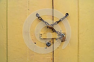 chain lock on the wooden yellow door. copy space