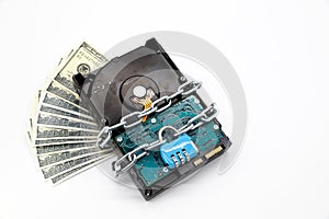 Chain locked with password protection on hard disk with money this image for security technology concept