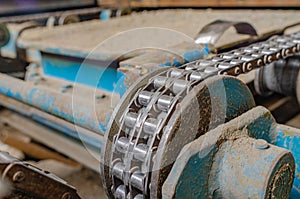 Chain on old equipment. Industrial background of worn chain device. Close-up