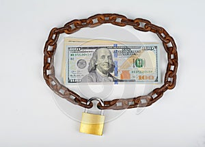 Chain with padlock around  cash money. Safe deposit concept