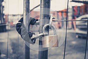 Chain and padlock on gate at construction site