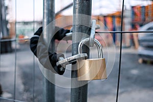 Chain and padlock on gate at construction site