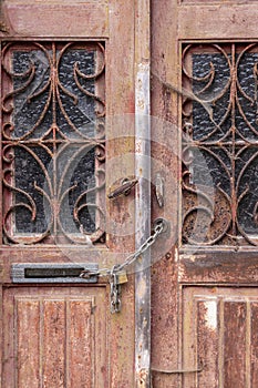 Chain and padlock on an old wooden door