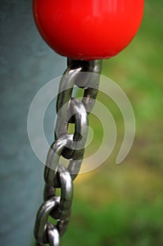 Chain of sturdy material. Metal, iron stainless steel that connects and fastens what is loose. Chained freedom and safety.