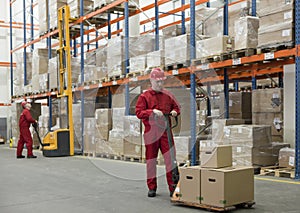 chain supply - two workers in storehouse photo