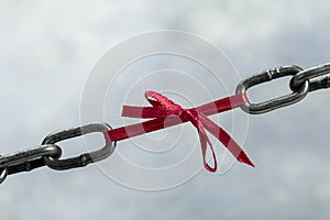 Chain tied by red ribbon