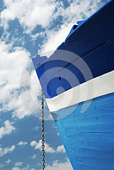 Chain of a white and blue wooden boat