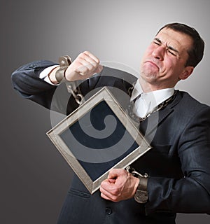 Chained businessman with a board photo