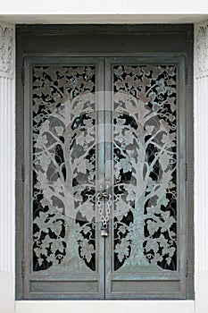 Chained metal doors with tree motif