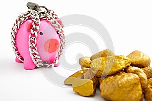 Chained piggy bank and gold