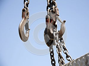 Chains with crane hook as industrial background