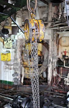 Chains hanging from a hoist in workshop