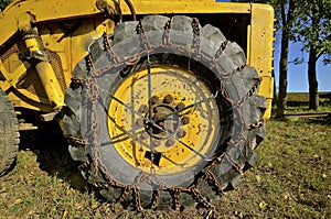 Chains on huge tire of an excavating machine