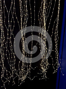 chains of light on a dark blue background resemble a starry sky at night.