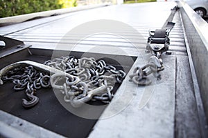 Chains resting on the bed of a tow truck