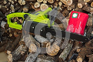 Chainsaw blade with first aid kit to indicate injury or incident at work