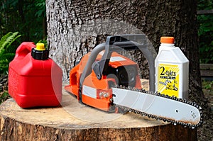 Chainsaw and canister of gasoline and motor oil