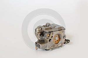 Chainsaw carburetor old on a white background.