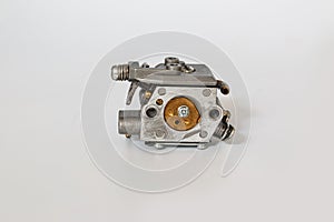 Chainsaw carburetor old on a white background..