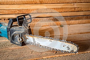 Chainsaw on lumber background