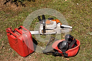 Chainsaw with petrol can and hardhat