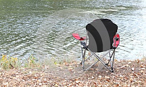 Chair in autumn in park near the river