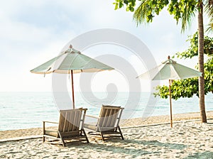 Chair Beach and Umbrella on Sand at Coast with blur Blue Sea and Cloud Sky Background Tropic Ocean Island Paradise with Sunny