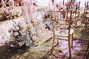 Chair decorated with flowers in Wedding ceremony.