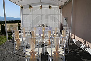 Chair decorated for the wedding. Beautiful wedding ceremony design decoration elements, floral design and chairs